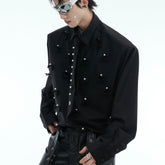 "A tailored shirt with pearl embellishment, shoulder pads and a men's tie, a loose cardigan with panels